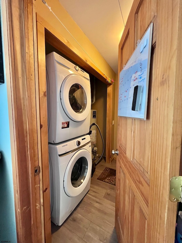 5323 S Carolina Ave, Mullica Township, NJ 08215 - laundry area featuring stacked washer and clothes dryer and light wood-style flooring