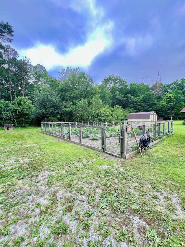 5323 S Carolina Ave, Mullica Township, NJ 08215 - view of yard with a vegetable garden, a wooded view, and an outdoor structure