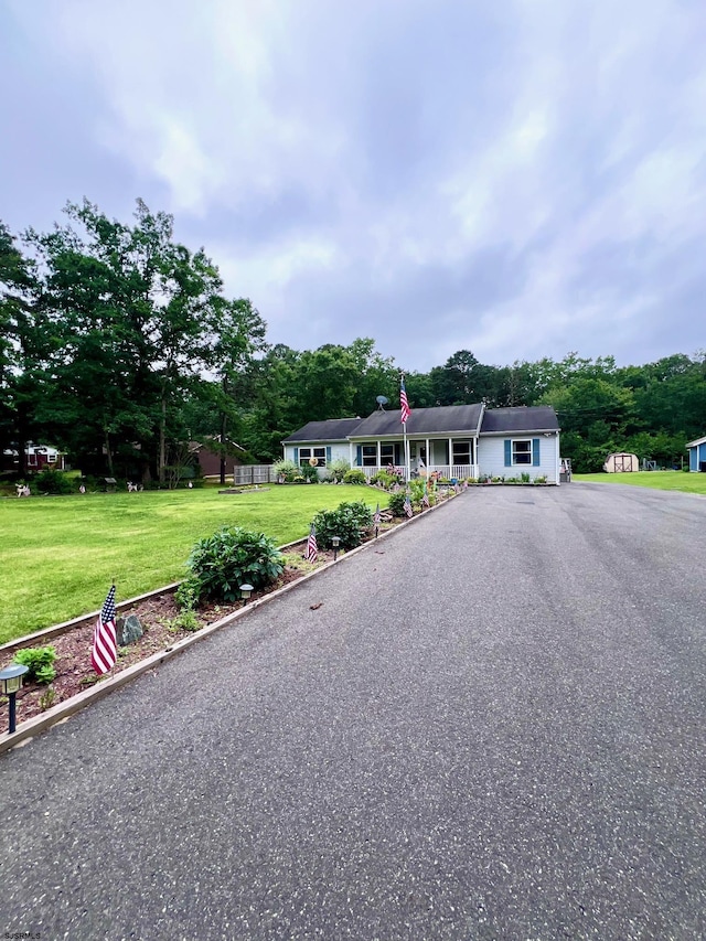 5323 S Carolina Ave, Mullica Township, NJ 08215 - ranch-style home featuring a front yard, asphalt driveway, and view of wooded area