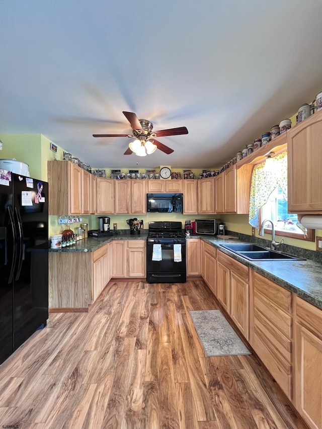 5323 S Carolina Ave, Mullica Township, NJ 08215 - kitchen with black appliances, light brown cabinetry, light wood-style floors, dark countertops, and ceiling fan