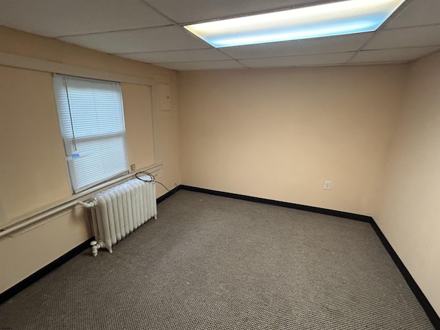 614 Caspian Ave, Atlantic City, NJ 08401 - empty room featuring radiator, dark carpet, and a paneled ceiling