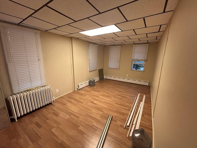 614 Caspian Ave, Atlantic City, NJ 08401 - finished below grade area with a baseboard radiator, radiator heating unit, wood finished floors, and a drop ceiling