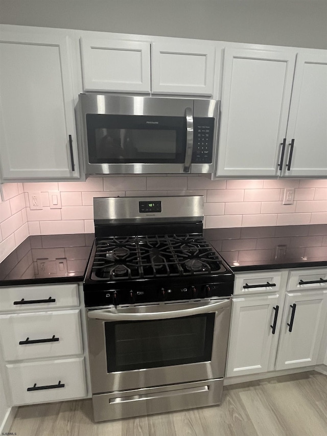 41 Arapaho Pl Unit 41, Galloway Township, NJ 08205 - kitchen featuring appliances with stainless steel finishes, dark countertops, white cabinetry, and decorative backsplash