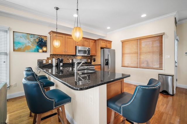 33 N Jefferson Ave, Margate, NJ 08402 - kitchen featuring stainless steel appliances, a breakfast bar area, light wood-style flooring, tasteful backsplash, and crown molding