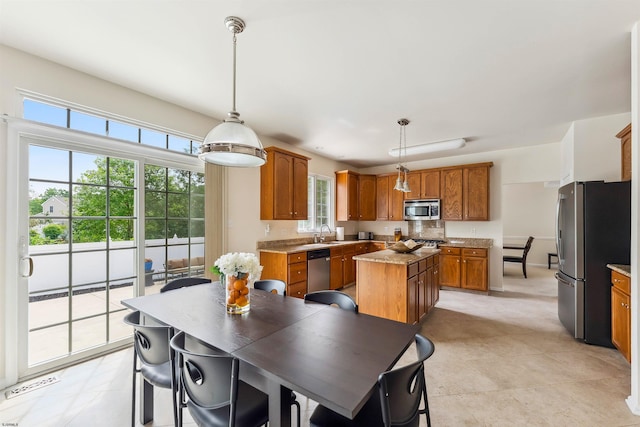 95 Knights Bridge Way, Mays Landing, NJ 08402 - kitchen featuring stainless steel appliances, brown cabinets, a kitchen island, and plenty of natural light