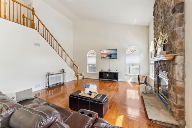 95 Knights Bridge Way, Mays Landing, NJ 08402 - living area with stairway, high vaulted ceiling, wood-type flooring, a fireplace, and plenty of natural light