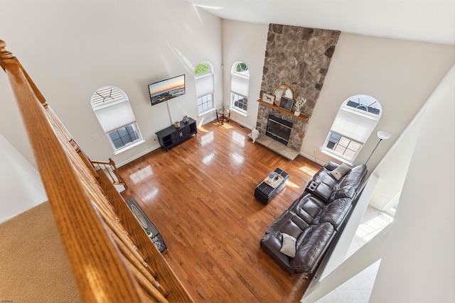 95 Knights Bridge Way, Mays Landing, NJ 08402 - living area with a towering ceiling, wood finished floors, a stone fireplace, and stairway