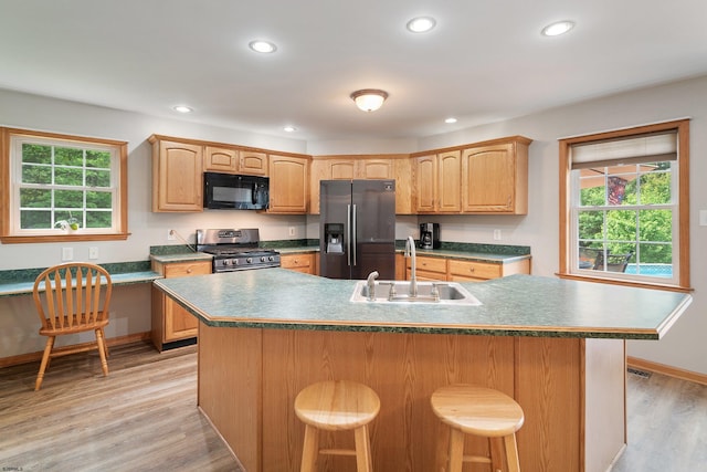 10 Hillside Ave, New Gretna, NJ 08087 - kitchen featuring appliances with stainless steel finishes, light wood-style flooring, recessed lighting, a breakfast bar area, and an island with sink