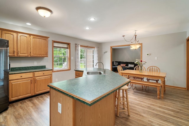 10 Hillside Ave, New Gretna, NJ 08087 - kitchen with light wood-style flooring, an island with sink, a kitchen bar, recessed lighting, and decorative light fixtures