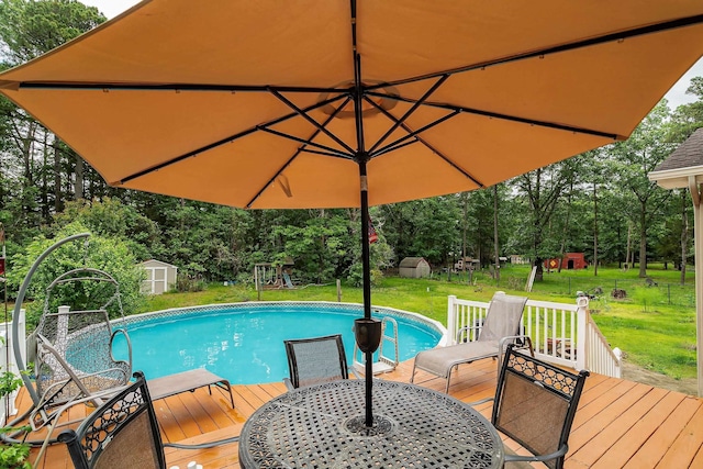 10 Hillside Ave, New Gretna, NJ 08087 - outdoor pool with a storage shed, a deck, a yard, and view of scattered trees