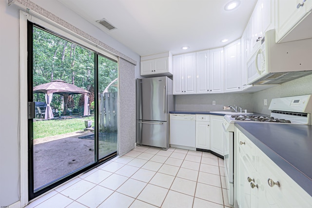 298 Mattix Run Unit 298, Galloway Township, NJ 08205 - kitchen with white appliances, white cabinets, dark countertops, light tile patterned floors, and recessed lighting