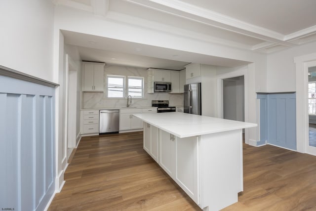 412 11th St Unit 2, Ocean City, NJ 08226 - kitchen featuring stainless steel appliances, white cabinets, beamed ceiling, dark wood finished floors, and a center island