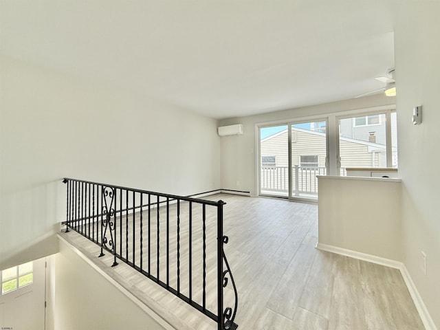 3400 W Brigantine Ave Unit 3, Brigantine, NJ 08203 - hallway with wood finished floors, a wall mounted AC, and an upstairs landing