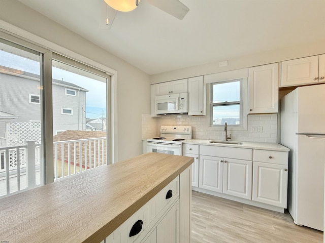 3400 W Brigantine Ave Unit 3, Brigantine, NJ 08203 - kitchen featuring white appliances, light wood-type flooring, light countertops, and tasteful backsplash