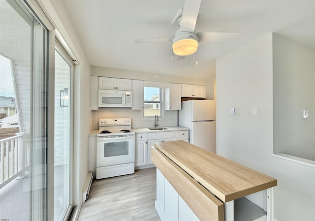3400 W Brigantine Ave Unit 3, Brigantine, NJ 08203 - kitchen with white appliances, white cabinetry, light countertops, backsplash, and light wood-type flooring