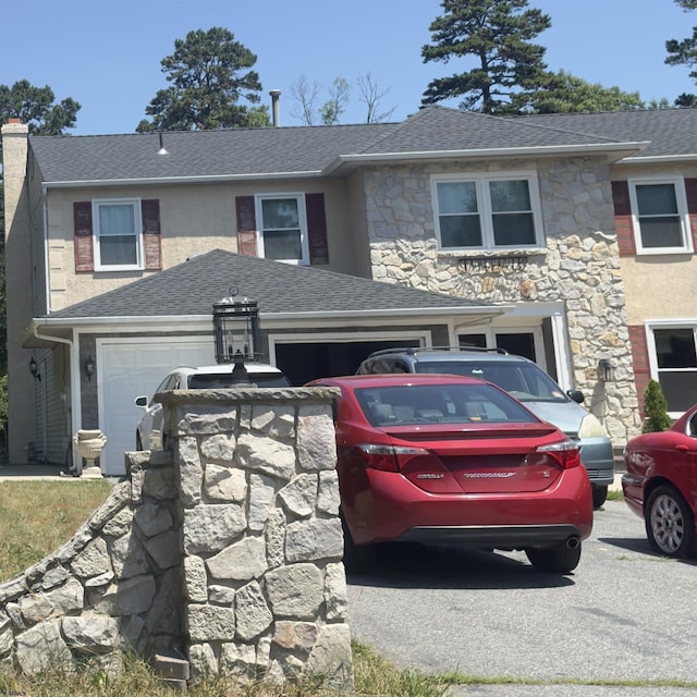 2453 Lahn Ln, Mays Landing, NJ 08330 - view of front of property with stone siding, an attached garage, driveway, roof with shingles, and a chimney
