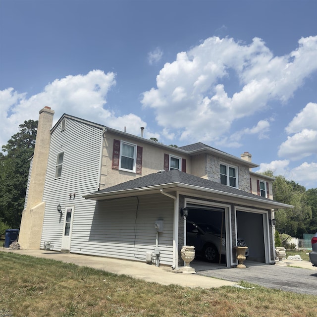 2453 Lahn Ln, Mays Landing, NJ 08330 - back of property featuring a chimney, asphalt driveway, and an attached garage