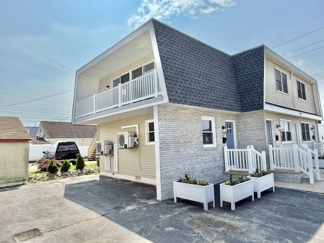 3400 W Brigantine Ave Unit 4, Brigantine, NJ 08203 - view of front of house featuring roof with shingles, brick siding, and a balcony