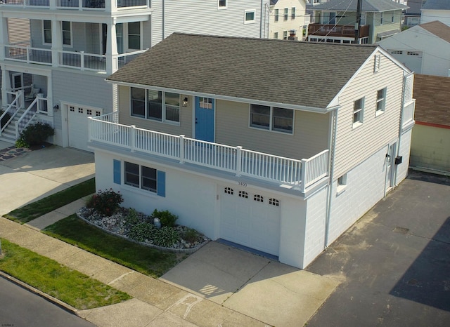 3400 W Brigantine Ave Unit 5, Brigantine, NJ 08203 - view of front of house featuring an attached garage, driveway, a balcony, and roof with shingles
