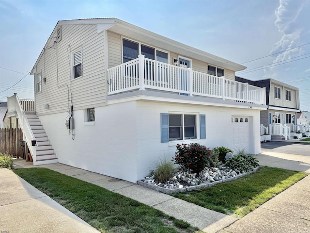 3400 W Brigantine Ave Unit 5, Brigantine, NJ 08203 - view of front facade featuring a balcony, a garage, stairway, and driveway