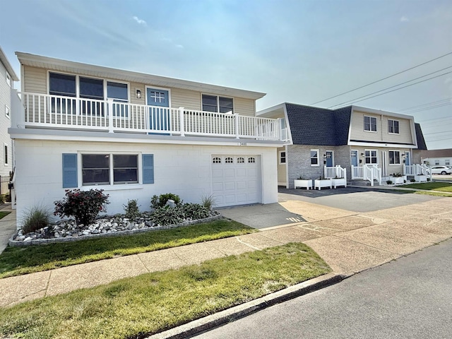 3400 W Brigantine Ave Unit 5, Brigantine, NJ 08203 - view of front facade featuring a balcony, driveway, a garage, and roof with shingles