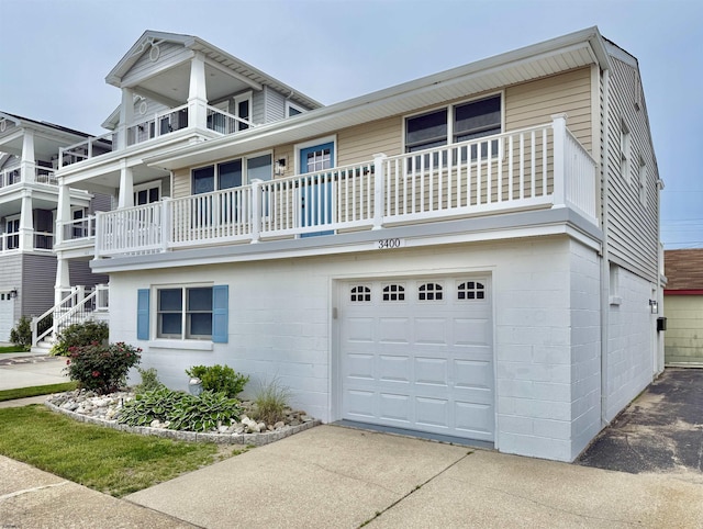 3400 W Brigantine Ave Unit 5, Brigantine, NJ 08203 - view of front of house featuring an attached garage, concrete block siding, a balcony, and driveway