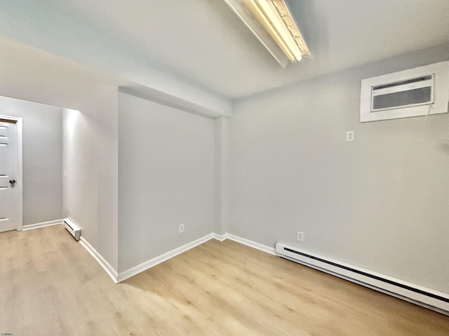3400 W Brigantine Ave Unit 5, Brigantine, NJ 08203 - unfurnished room with a baseboard heating unit, light wood-style floors, a wall mounted AC, and baseboard heating