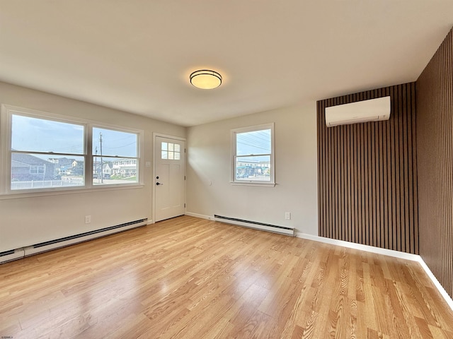3400 W Brigantine Ave, Brigantine, NJ 08203 - unfurnished room with baseboard heating, a wall mounted AC, and light wood-style flooring