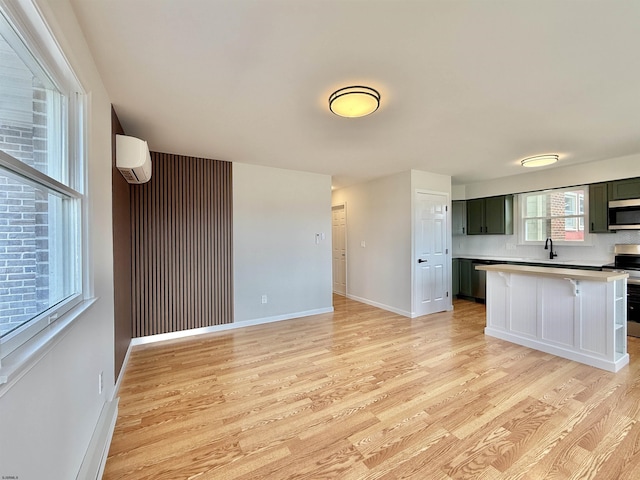 3400 W Brigantine Ave, Brigantine, NJ 08203 - kitchen featuring stainless steel appliances, light wood-style flooring, a wall mounted air conditioner, and light countertops