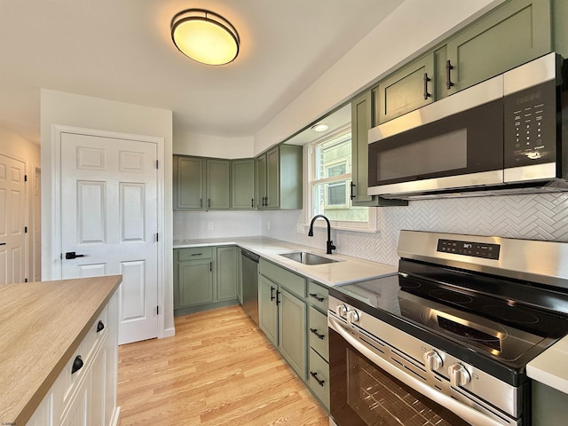 3400 W Brigantine Ave, Brigantine, NJ 08203 - kitchen featuring appliances with stainless steel finishes, green cabinetry, backsplash, and light countertops