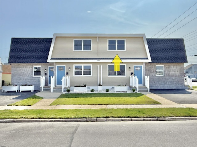 3400 W Brigantine Ave, Brigantine, NJ 08203 - view of front facade with brick siding, a front lawn, and a shingled roof