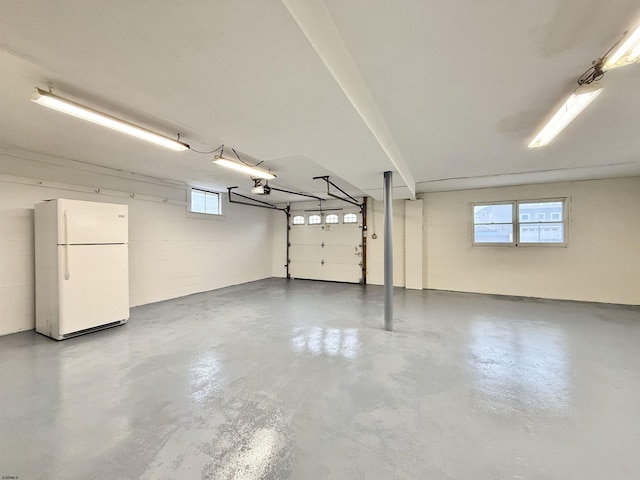 3400 W Brigantine Ave, Brigantine, NJ 08203 - garage featuring freestanding refrigerator, a garage door opener, and concrete block wall