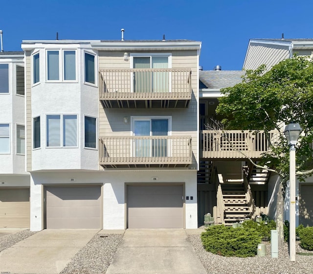 24 Coquille Beach Dr Unit 24, Brigantine, NJ 08203 - view of building exterior with a garage, driveway, and stairway