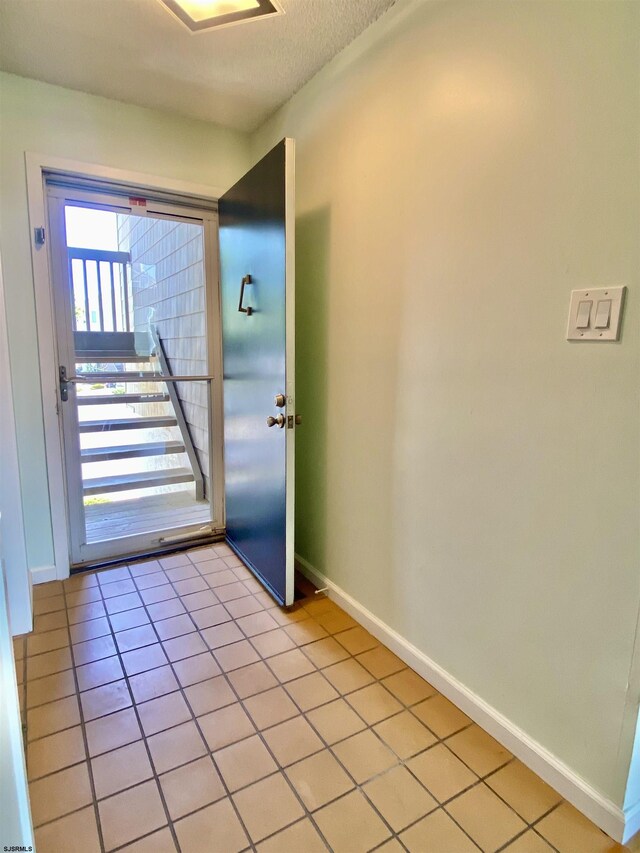 24 Coquille Beach Dr Unit 24, Brigantine, NJ 08203 - foyer entrance featuring light tile patterned floors and a textured ceiling