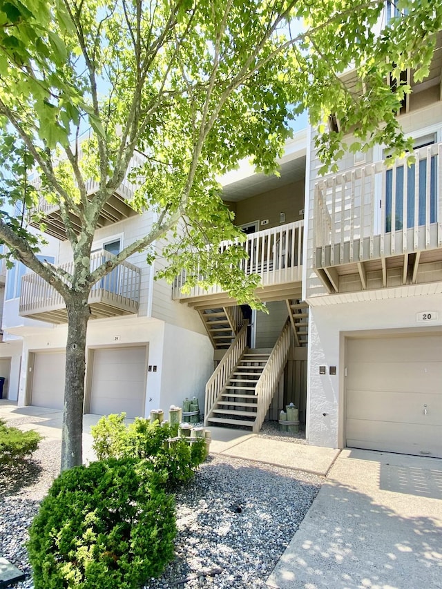 24 Coquille Beach Dr Unit 24, Brigantine, NJ 08203 - view of front facade featuring a garage, stucco siding, and stairs