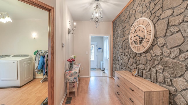 6015 Main St, Mays Landing, NJ 08330 - hallway with washing machine and clothes dryer, a chandelier, light wood finished floors, and radiator heating unit