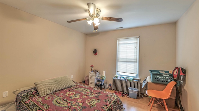 6015 Main St, Mays Landing, NJ 08330 - bedroom featuring radiator heating unit, wood finished floors, and ceiling fan