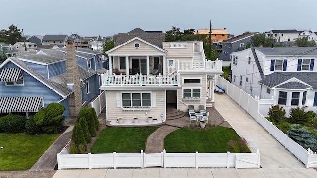 713 W Brigantine Ave, Brigantine, NJ 08203 - back of house featuring a residential view, a fenced backyard, and a balcony