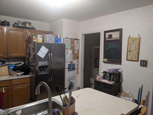 192 Exton Rd, Somers Point, NJ 08244 - kitchen with stainless steel fridge, brown cabinets, and light countertops