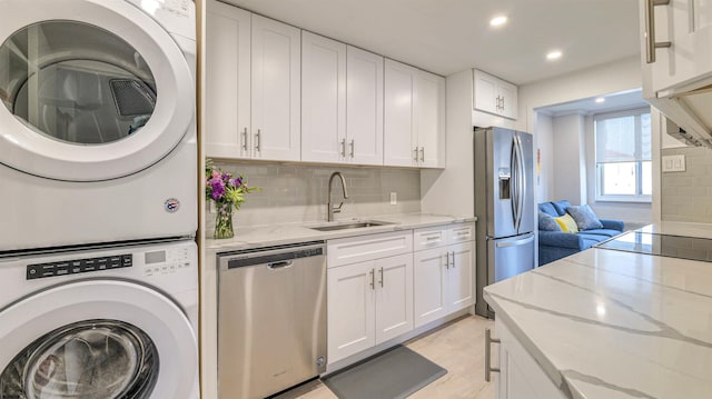 5000 Boardwalk Unit 107, Ventnor, NJ 08406 - laundry room with stacked washer / dryer, recessed lighting, and light wood-style floors
