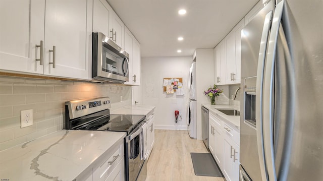 5000 Boardwalk Unit 107, Ventnor, NJ 08406 - kitchen featuring appliances with stainless steel finishes, recessed lighting, tasteful backsplash, white cabinetry, and light wood-type flooring
