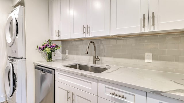 5000 Boardwalk Unit 107, Ventnor, NJ 08406 - kitchen featuring dishwasher, stacked washer / drying machine, white cabinetry, and tasteful backsplash