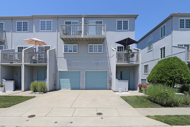 417 Albacore Ln, Brigantine, NJ 08203 - view of front facade featuring driveway, a garage, and a balcony