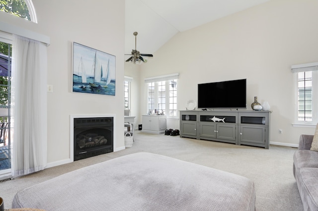 417 Albacore Ln, Brigantine, NJ 08203 - living room with light colored carpet, a ceiling fan, high vaulted ceiling, and a fireplace