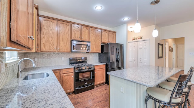 34 Gasko Rd, Mays Landing, NJ 08330 - kitchen featuring black appliances, a breakfast bar, backsplash, a center island, and recessed lighting