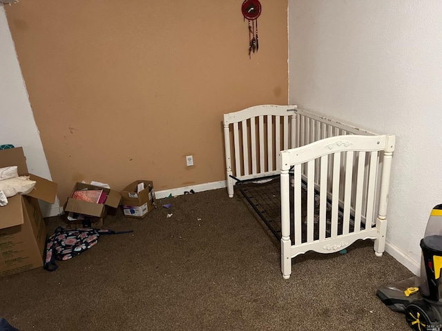 carpeted bedroom featuring a nursery area