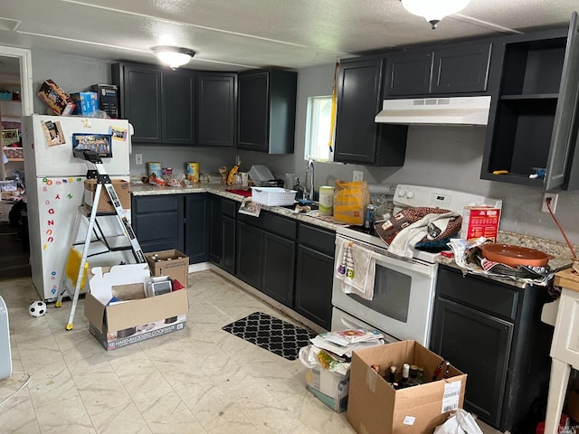 kitchen featuring white appliances, a textured ceiling, and light tile floors