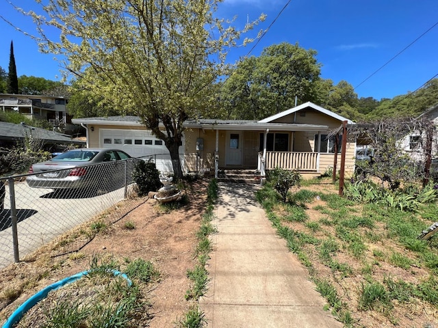 view of front of home featuring covered porch and a garage