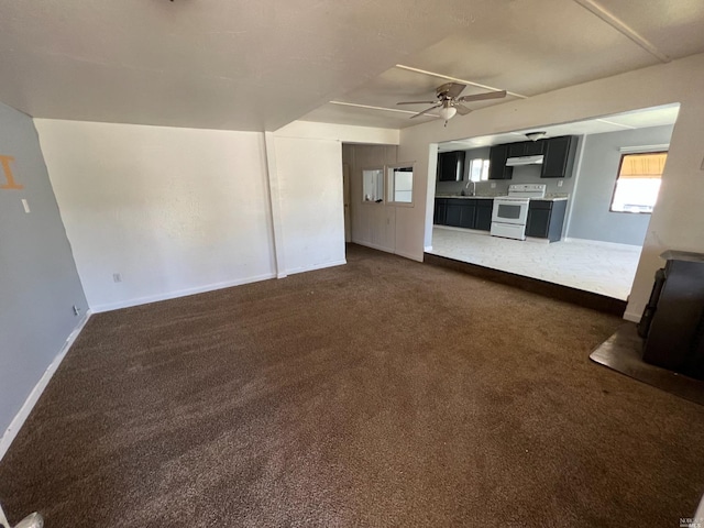 interior space featuring ceiling fan and sink