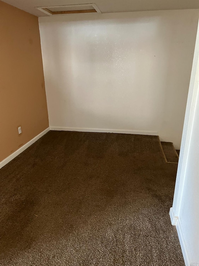 empty room featuring dark carpet